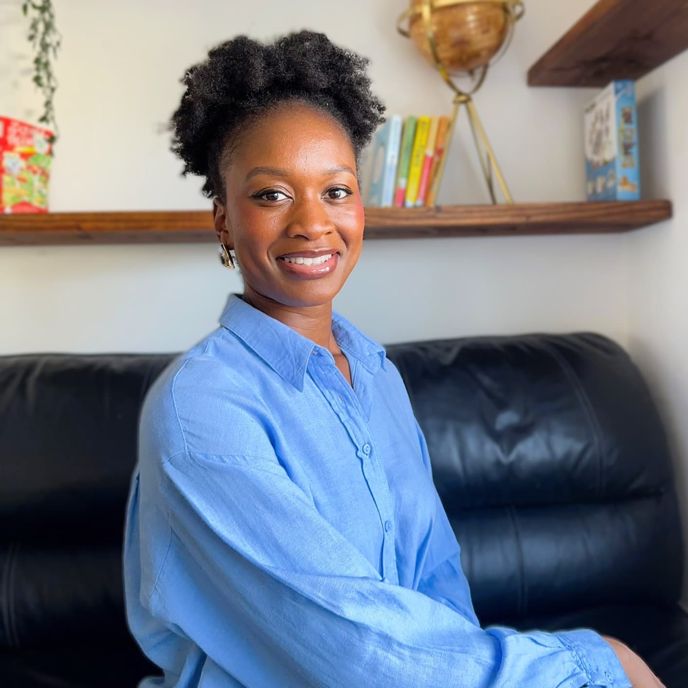 Ms Betty smiling, seated in her tutoring room